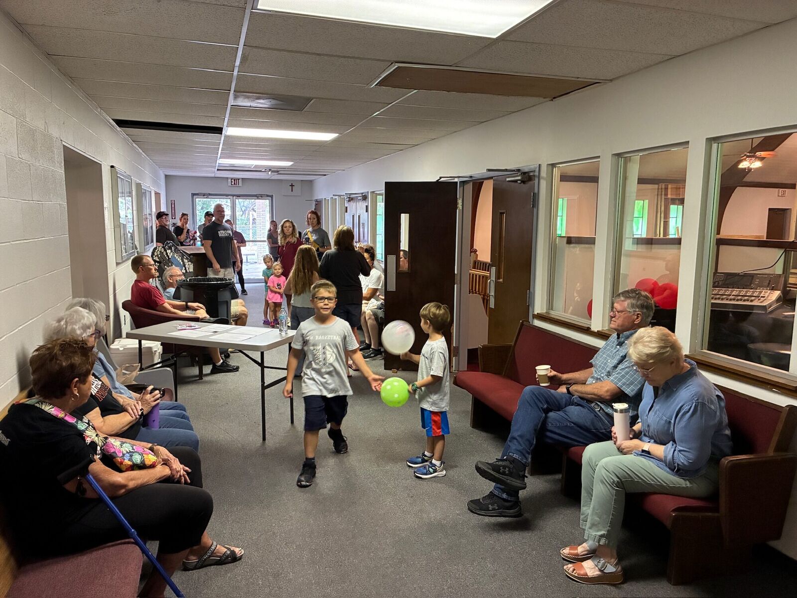 Connect Church families visiting in the hallway before service