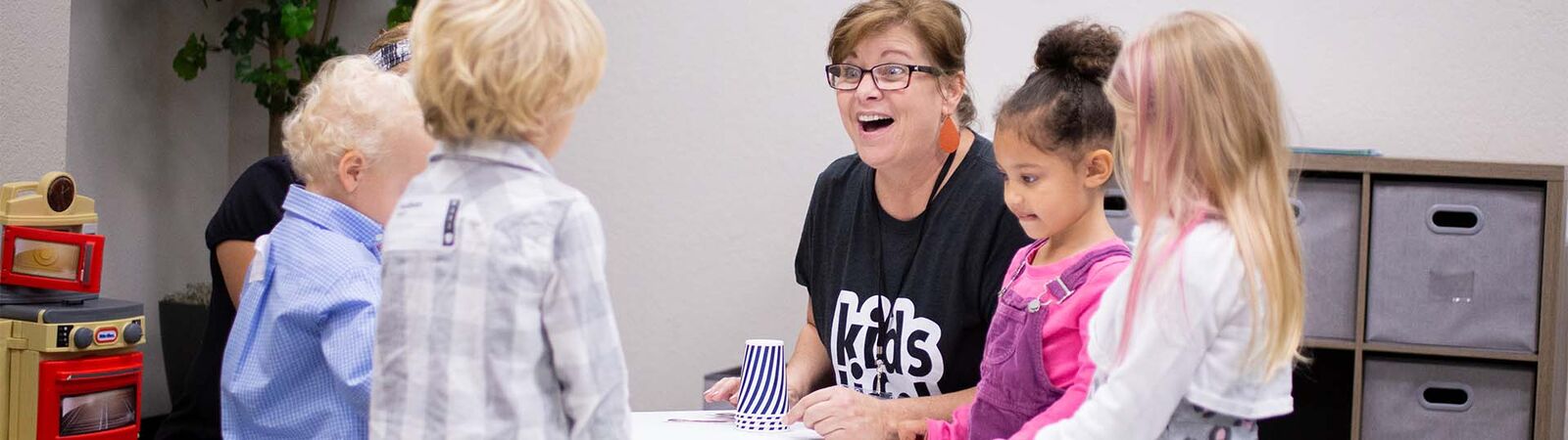A Connect Kids volunteer celebrating with kids