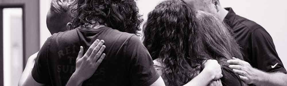 Two people praying together at Connect Church